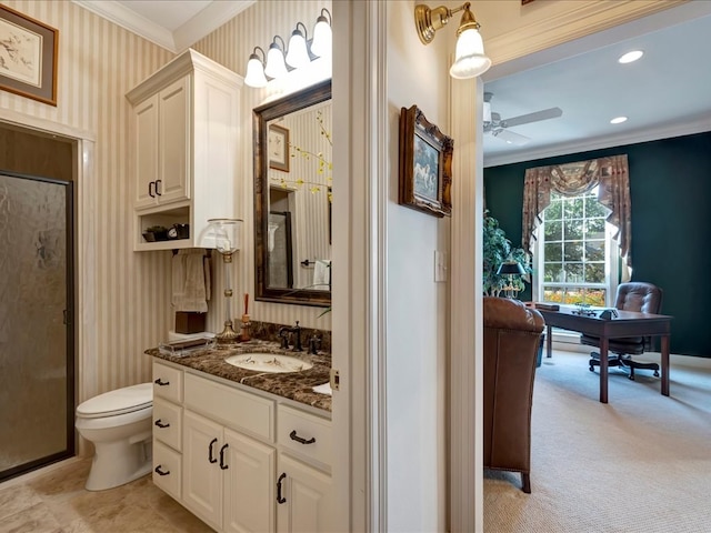 bathroom with vanity, crown molding, ceiling fan, toilet, and walk in shower