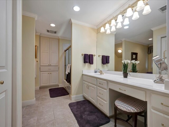 bathroom featuring vanity, tile patterned floors, a shower with door, and ornamental molding