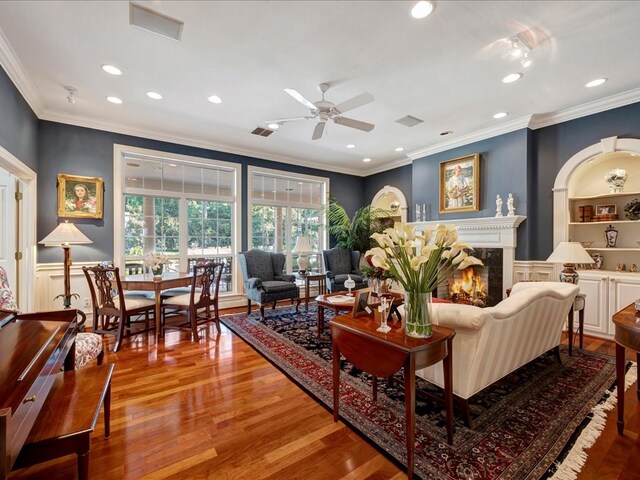 living room featuring ceiling fan, light hardwood / wood-style flooring, and ornamental molding