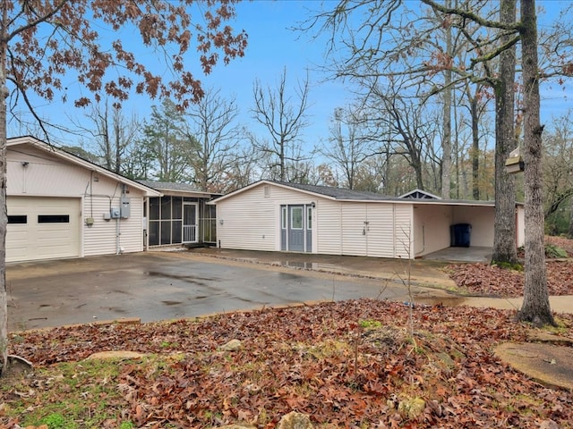 exterior space with a carport, a sunroom, and a garage