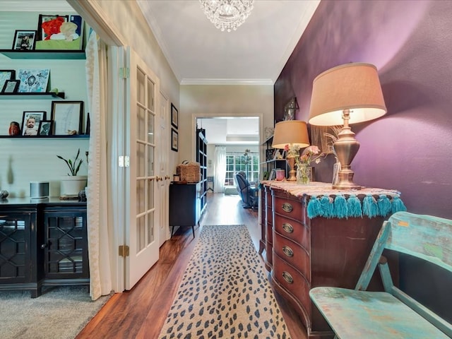 corridor with a chandelier, french doors, hardwood / wood-style flooring, and crown molding