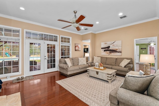 living room featuring ornamental molding, hardwood / wood-style floors, ceiling fan, and french doors