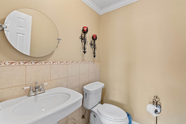 bathroom featuring tile walls, sink, crown molding, and toilet