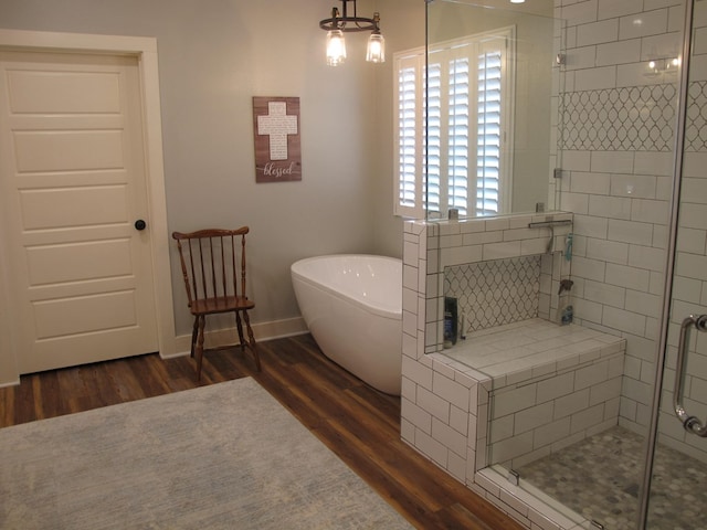 1208 Leslie Ln, Lufkin, TX 75901 - full bath featuring wood finished floors, a stall shower, and a soaking tub