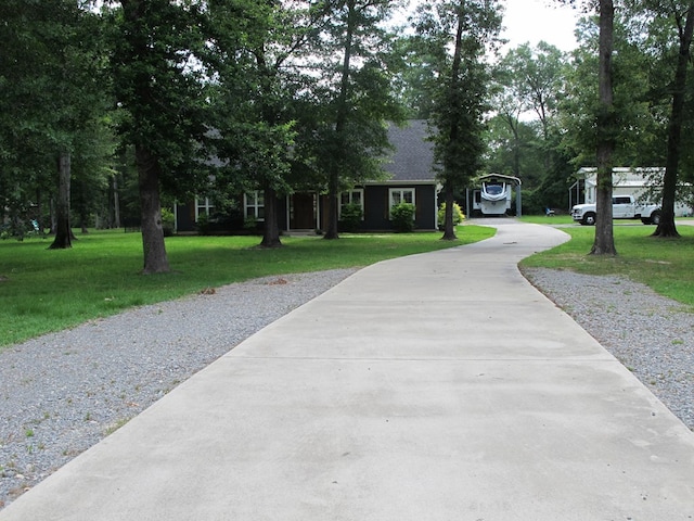1208 Leslie Ln, Lufkin, TX 75901 - view of front of home featuring driveway, a front yard, and a carport