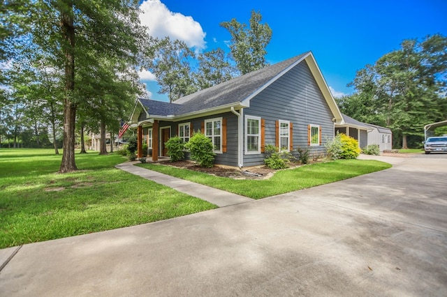 1208 Leslie Ln, Lufkin, TX 75901 - view of property exterior featuring concrete driveway, a lawn, and a shingled roof