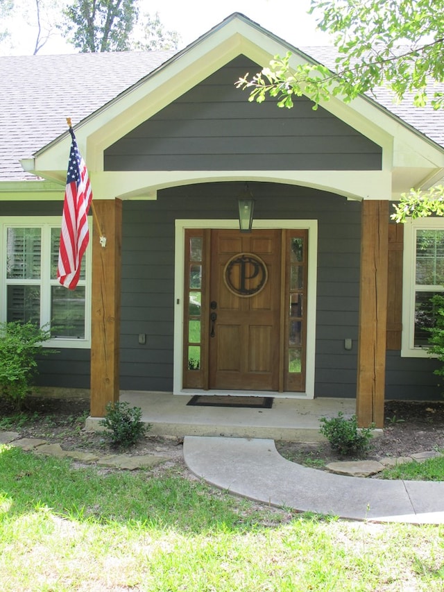 1208 Leslie Ln, Lufkin, TX 75901 - view of exterior entry with a shingled roof and covered porch