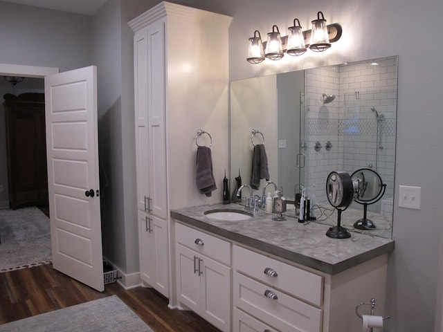 1208 Leslie Ln, Lufkin, TX 75901 - bathroom featuring wood finished floors, vanity, and a stall shower