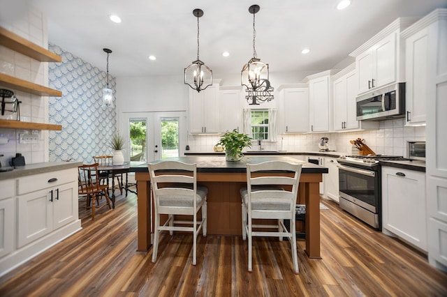 1208 Leslie Ln, Lufkin, TX 75901 - kitchen featuring appliances with stainless steel finishes, backsplash, white cabinets, and recessed lighting