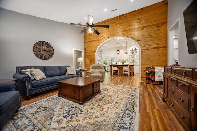1208 Leslie Ln, Lufkin, TX 75901 - living room featuring wooden walls, arched walkways, ceiling fan, wood finished floors, and recessed lighting