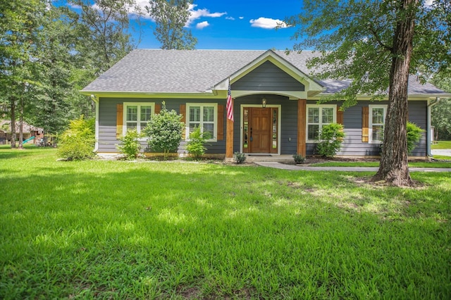 1208 Leslie Ln, Lufkin, TX 75901 - view of front of house with roof with shingles, a front lawn, and a porch