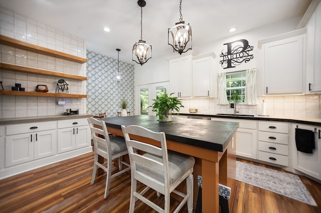 1208 Leslie Ln, Lufkin, TX 75901 - kitchen with dark countertops, backsplash, healthy amount of natural light, and recessed lighting