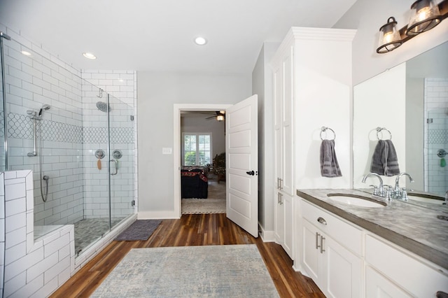 1208 Leslie Ln, Lufkin, TX 75901 - bathroom with wood finished floors, a stall shower, ceiling fan, vanity, and ensuite bathroom