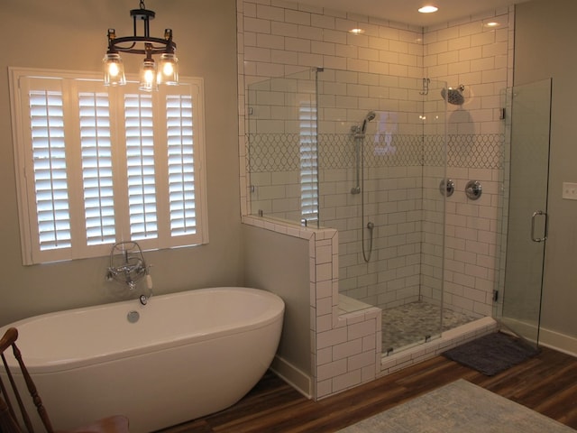 1208 Leslie Ln, Lufkin, TX 75901 - full bath featuring wood finished floors, a stall shower, and a soaking tub