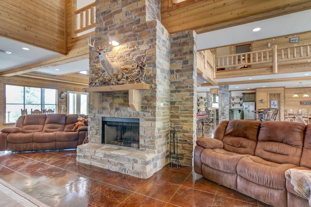 tiled living room featuring beam ceiling, a stone fireplace, and a high ceiling