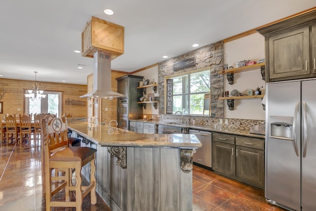 kitchen with island exhaust hood, a kitchen breakfast bar, stainless steel appliances, and an island with sink