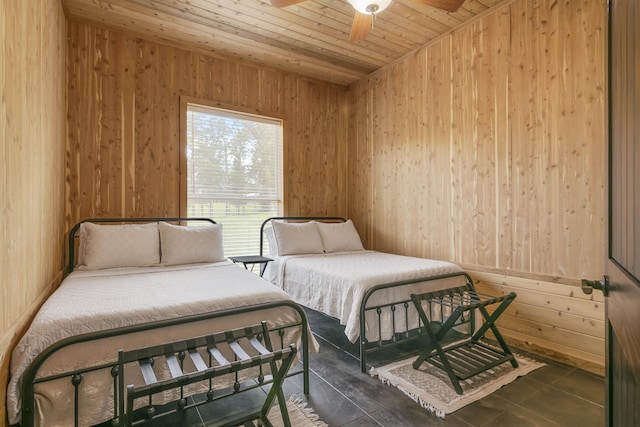 tiled bedroom with ceiling fan, wooden walls, and wood ceiling