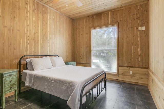 tiled bedroom with ceiling fan, wooden walls, and wood ceiling