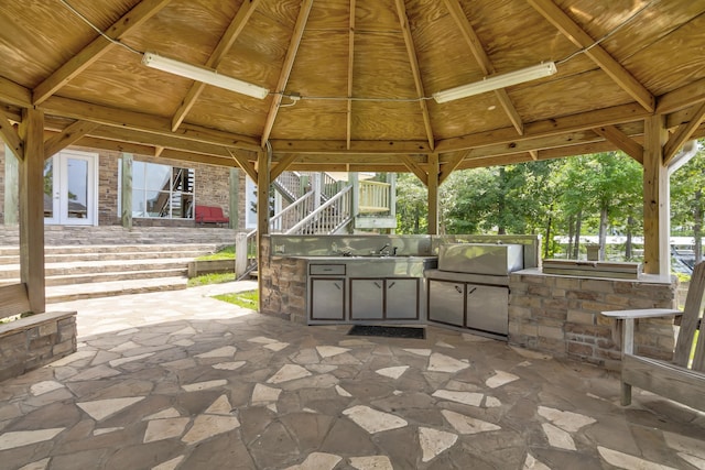 view of patio / terrace with a gazebo, an outdoor kitchen, and sink