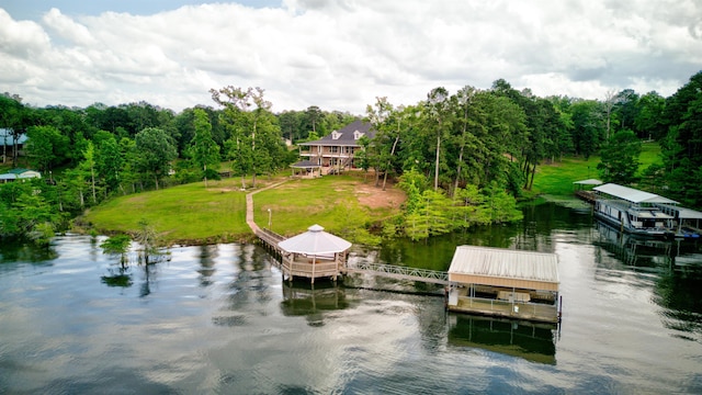 view of dock featuring a yard and a water view