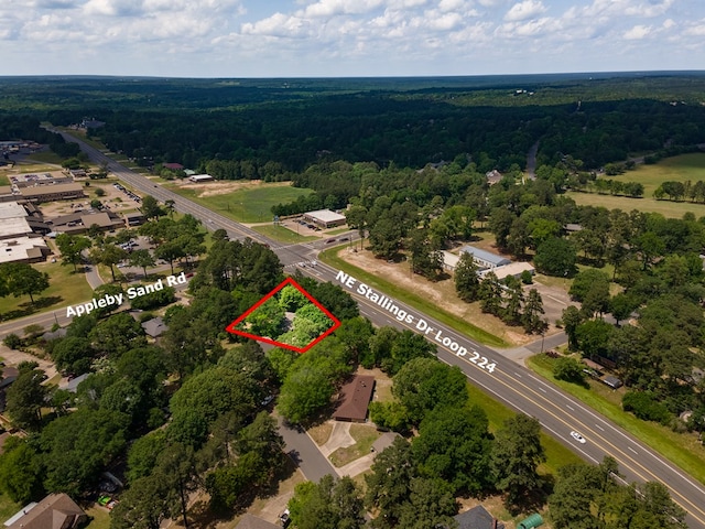 birds eye view of property featuring a wooded view