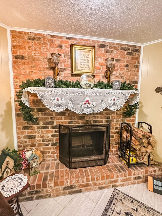 room details featuring wood finished floors, ornamental molding, a brick fireplace, and a textured ceiling