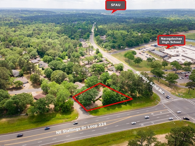birds eye view of property with a wooded view