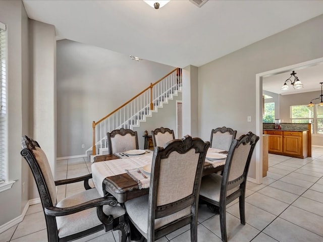 tiled dining area with an inviting chandelier