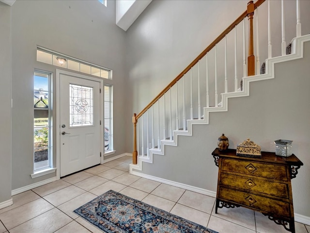 foyer with light tile patterned flooring and a high ceiling