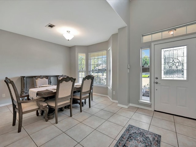 dining room with light tile patterned floors and a wealth of natural light