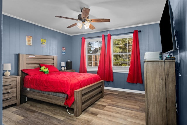 bedroom with ceiling fan, ornamental molding, wood finished floors, and baseboards