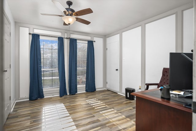 office area with a ceiling fan and wood finished floors