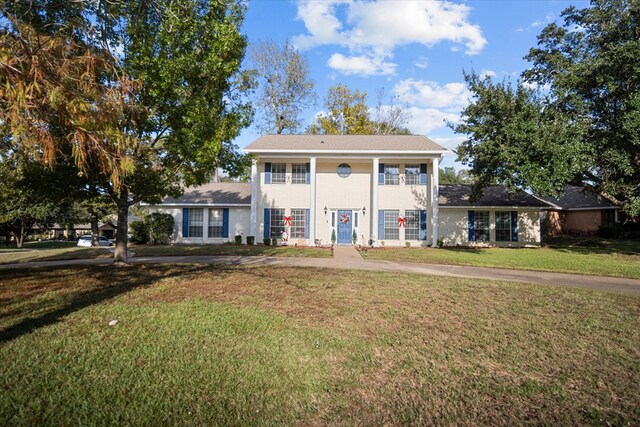 neoclassical / greek revival house with a front lawn