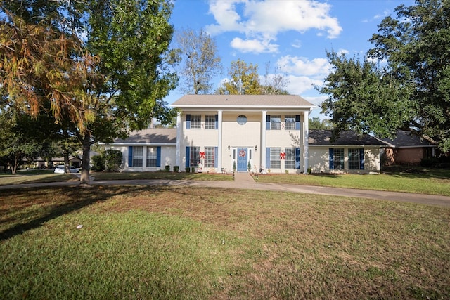 greek revival house with french doors and a front lawn