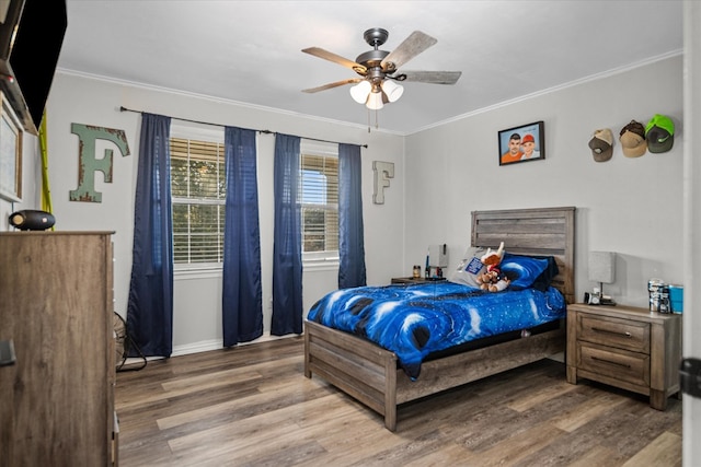 bedroom with ceiling fan, wood-type flooring, and ornamental molding