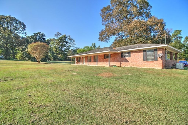 rear view of property featuring a yard