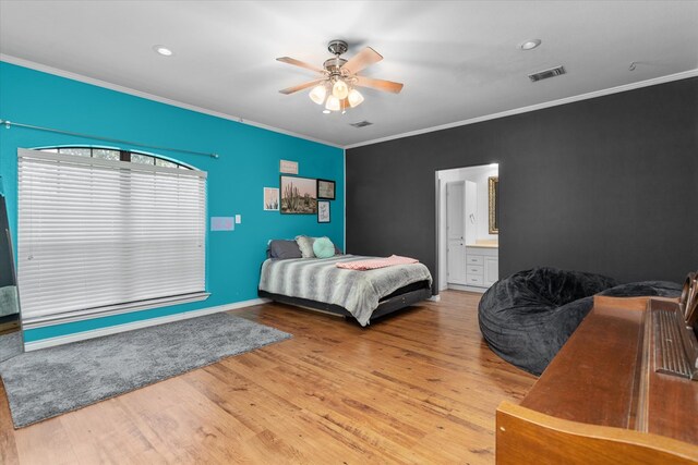 bedroom with light hardwood / wood-style floors, ensuite bath, ceiling fan, and ornamental molding