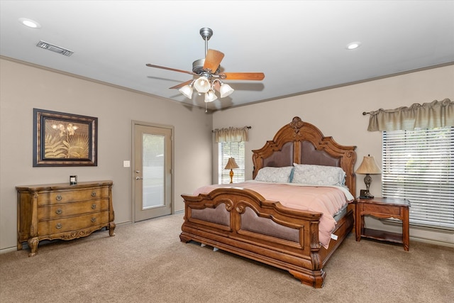 carpeted bedroom with access to outside, multiple windows, ceiling fan, and crown molding