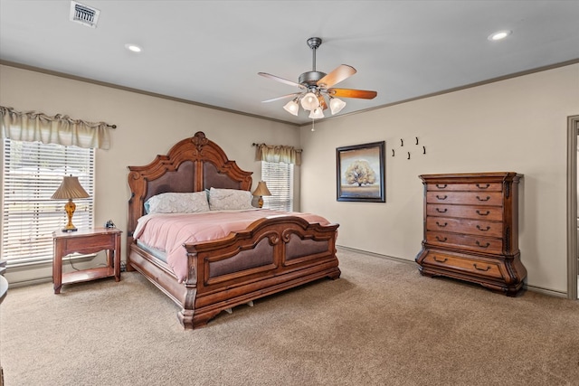 bedroom with ceiling fan, crown molding, and carpet floors