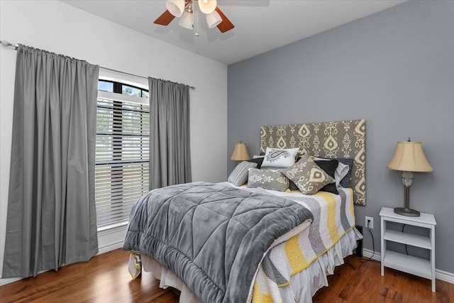 bedroom with ceiling fan and dark hardwood / wood-style flooring