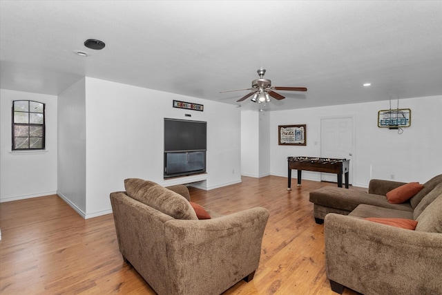 living room featuring ceiling fan and light hardwood / wood-style flooring