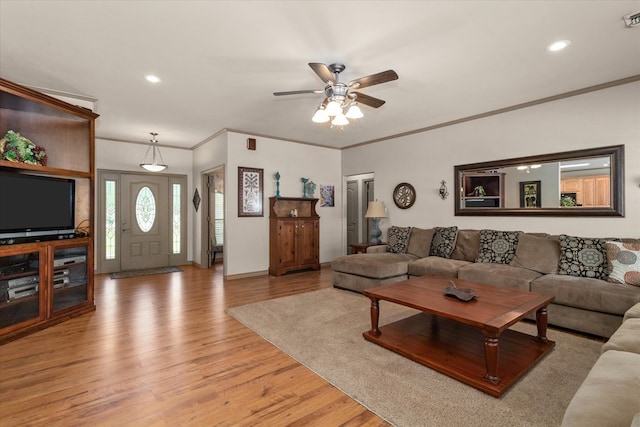 living room featuring light hardwood / wood-style floors, ceiling fan, and ornamental molding