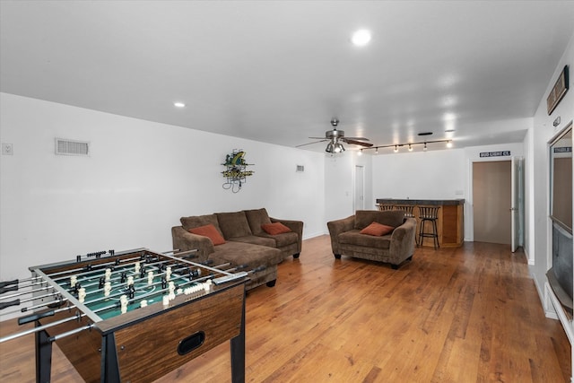 playroom with hardwood / wood-style floors and bar