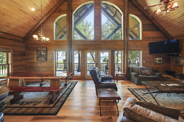 living room with hardwood / wood-style floors, high vaulted ceiling, and a healthy amount of sunlight