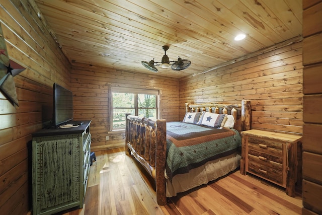 bedroom with wooden walls, light hardwood / wood-style flooring, ceiling fan, and wooden ceiling