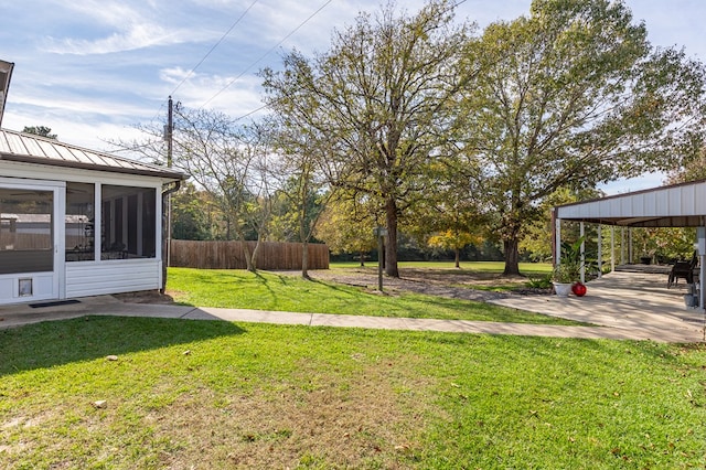 view of yard featuring a sunroom and fence