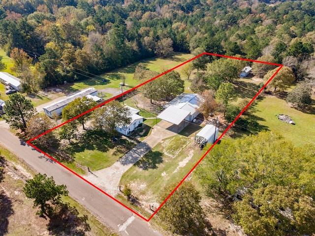birds eye view of property with a wooded view