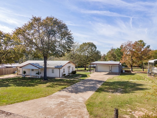 view of front facade featuring a front yard, metal roof, and a garage