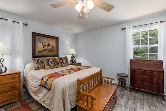 bedroom with baseboards, a ceiling fan, and wood finished floors