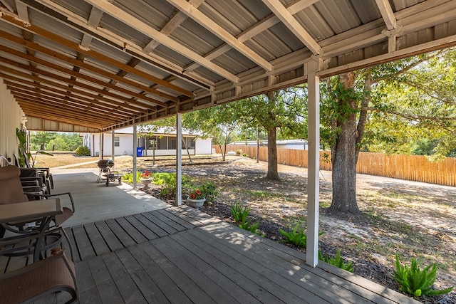 wooden terrace with a patio area and a fenced backyard